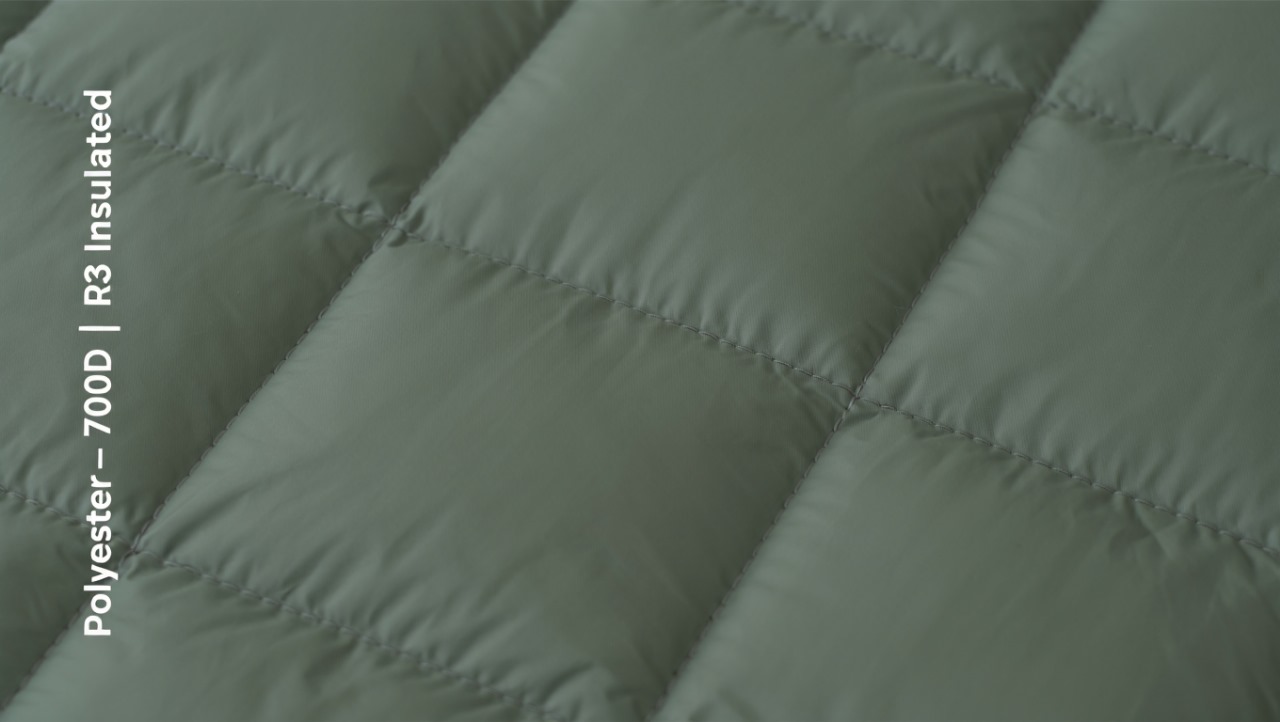 Insulated 700D polyester fabric with quilted appearance and dual-layer structure.